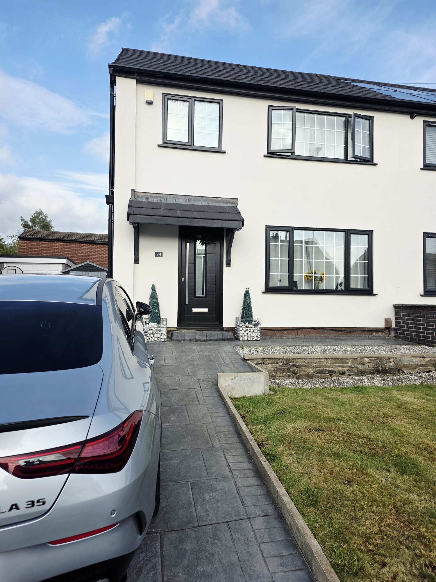 Anthracite windows and black composite front door on a white rendered detached house