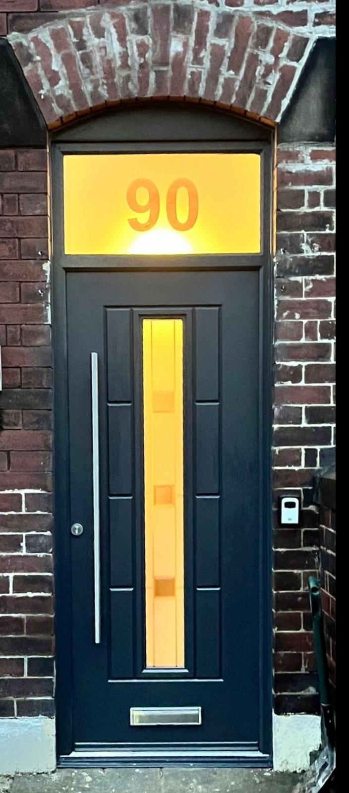 Navy composite front door with slim glazed panel and illuminated arched fanlight